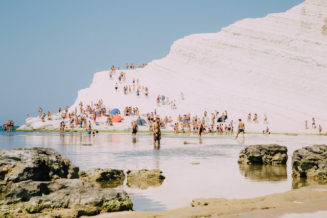 Top beach in Sicily, Scala Dei Turchi with people in the water