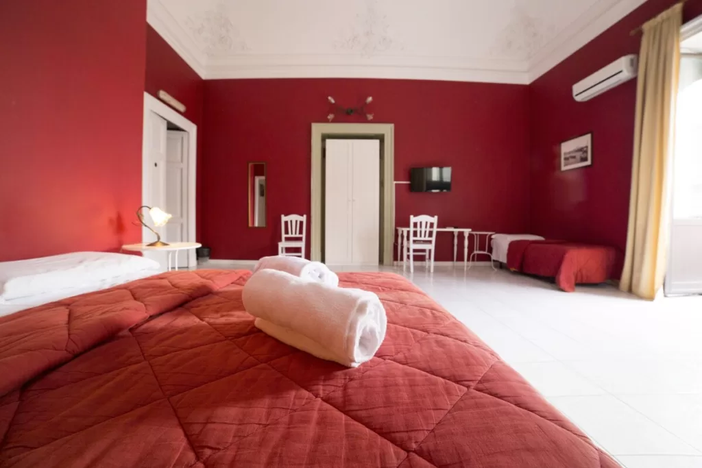 Hotel Biscari Catania room with red walls and red sheets