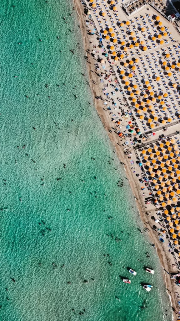 Ariel shot of Mondello Beach in Sicily with people in the water