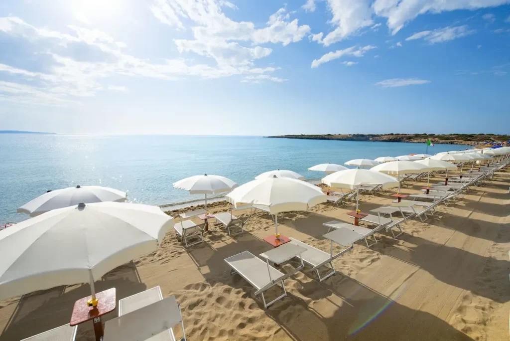 Voi Arenella Resort beach with umbrellas and sunbeds