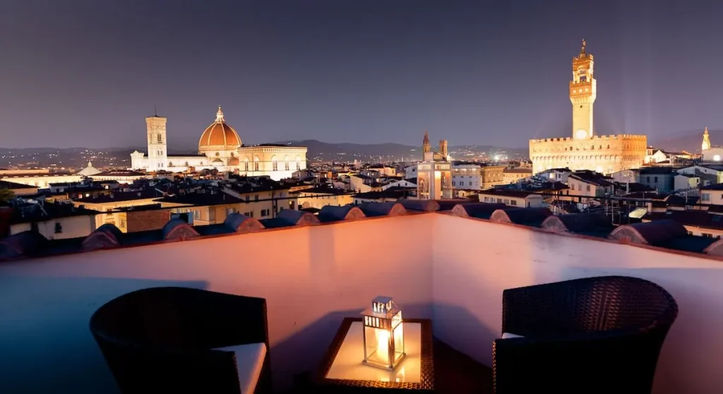 Hotel Torre Guelfa rooftop with view of Florence in the evening.
